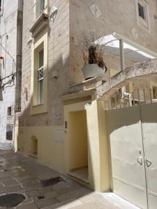 a building with two garage doors on a street at Le Dimore Di Puglia - Palazzo Pinto in Monopoli
