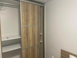 a closet with a wooden cabinet in a room at Nonny and family lifestyle in Athens