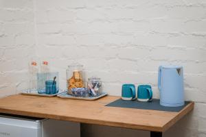 a wooden table with blue and white appliances on it at Mooi Uitsig Lodge in Paarl