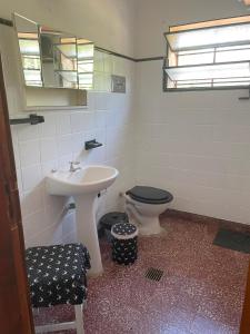 a bathroom with a sink and a toilet at La Casita de Córdoba in Capilla del Monte