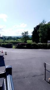 an empty parking lot with trees in the distance at Brittany's in Gisburn