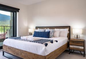 a bedroom with a large bed and a window at Stoke House by Revelstoke Vacations in Revelstoke