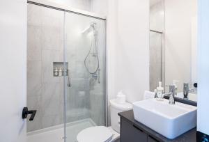 a bathroom with a shower and a sink and a toilet at Stoke House by Revelstoke Vacations in Revelstoke +28 photos