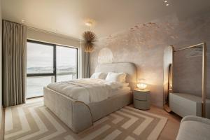 a bedroom with a bed and a large window at Vindlys Luxury Penthouse Apartment in Tromsø