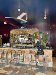 a man sitting at a bar in a restaurant at Elia’s Guest House in Paralia Saranti