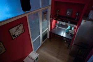 an overhead view of a kitchen with a table and a refrigerator at Vintage BDSM Kinky Apartment - ENTIRE 65m2 space for up to 6-guests - FULLY EQUIPPED in Wrocław