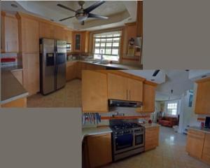 a kitchen with wooden cabinets and a stove top oven at Charleston Beach House Barbados in Bridgetown