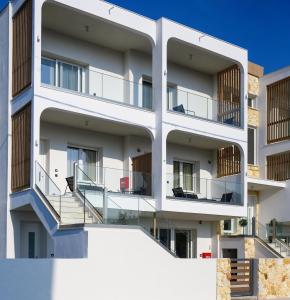 an apartment building with balconies and stairs at Evelio Living in Keramotí