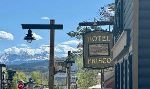 a sign for a hotel on a street with a mountain at Hotel Frisco in Frisco