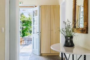 Una habitación con una mesa con un jarrón encima. en ALTHEA, en Panormos Skopelos