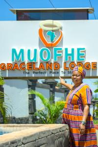 a woman standing in front of a muncie grape island lodge at Muofhe Graceland Lodge in Thohoyandou