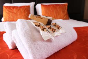 a pile of towels sitting on top of a bed at Muofhe Graceland Lodge in Thohoyandou