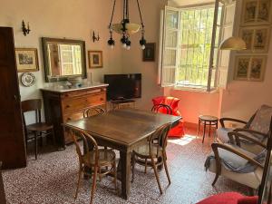 een woonkamer met een houten tafel en stoelen bij Villa con ampio giardino a due passi dal mare in SantʼAnna