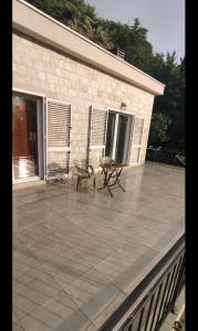 a patio with a table and a bench on a building at Guesthouse Nikoleta 2 in Kotor
