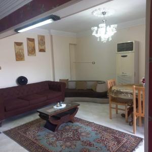 a living room with a couch and a table at Tanta طنطا Families Only in Tanta