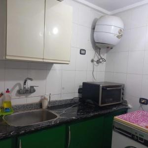 a kitchen counter with a sink and a microwave at Aqua Tanta Group طنطا Families Only in Tanta