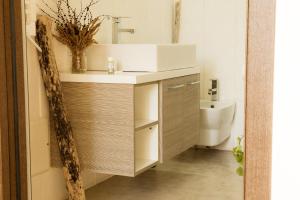 a bathroom with a sink and a toilet at Casale alle Vigne in Nardò +37 photos