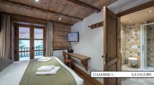 a bedroom with a bed and a bathroom at Chalet K120 - Village du Praz - Courchevel in Courchevel