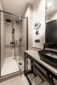 a bathroom with a sink and a shower at Palazzo Romano Suite 2 in Split +10 photos