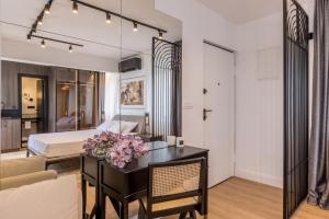 a bedroom with a bed and a desk with flowers on it at Palazzo Romano Suite 2 in Split