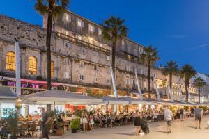 a crowd of people walking in front of a building at Palazzo Romano Suite 2 in Split