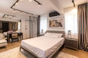a bedroom with a bed and a dining room at Palazzo Romano Suite 2 in Split