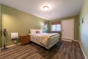 a bedroom with a bed and a dresser and a door at Elk Meadow Cabins 15B Lady Bird - Single Room in Orick