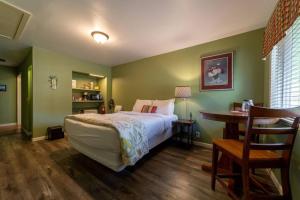 a bedroom with a bed and a table and a desk at Elk Meadow Cabins 15B Lady Bird - Single Room in Orick