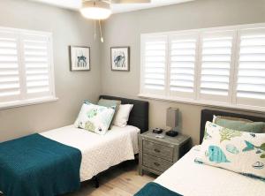 a bedroom with two beds and two windows at Modern Apartment - 2 of 4 in Punta Gorda