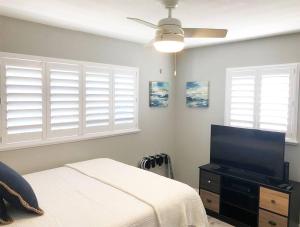 a bedroom with a bed and a flat screen tv at Modern Apartment - 2 of 4 in Punta Gorda