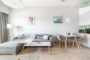 a living room with a couch and a table at Apartament Słoneczny Bulwar Ustka in Ustka