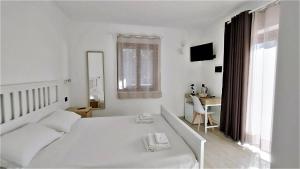 Postel nebo postele na pokoji v ubytování Zenia Rooms