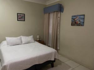 Кровать или кровати в номере Hotel Palermo Quintero