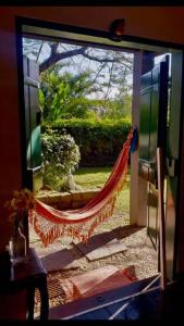 a window with a hammock outside of a door at Casa da árvore in Ubatuba