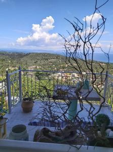 a balcony with a view of the ocean at Charming house with stunning view in Arvanitakaíïka