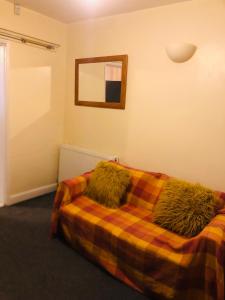 a bedroom with a bed with furry pillows on it at Tatia House in Gainsborough