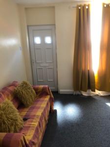 a room with a bed and a door with a window at Tatia House in Gainsborough