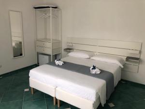 a bedroom with two beds and a dresser at La Strettoia in Caprioli