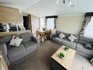 a living room with a couch and a table at Caravan Retreats in Conwy