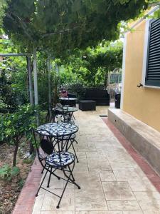 a patio with two chairs and a table with flowers at La Strettoia in Caprioli