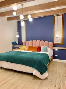 ein Schlafzimmer mit einem großen Bett mit blauer Wand in der Unterkunft Mid-Century Veek - puro diseño in Belén de Escobar