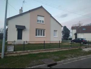 a white house with a fence in front of it at Maison au calme proche centre ville in Le Mans