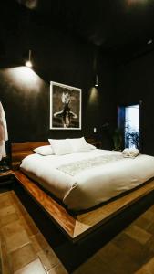 a bedroom with a large bed with a wooden frame at Hotel Sin Nombre in Oaxaca City