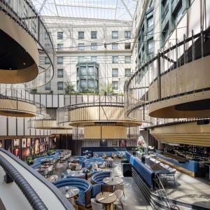 a view of a restaurant with tables and chairs at Radisson Collection Grand Place Brussels in Brussels