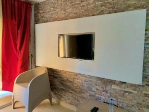 a room with a tv on a brick wall at Marina Wadi Degla Resort Families Only in Ain Sokhna