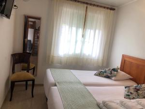 Ein Bett oder Betten in einem Zimmer der Unterkunft Airiños do Mar