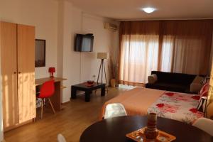 a hotel room with a bed and a table at Apartments Baja in Ulcinj