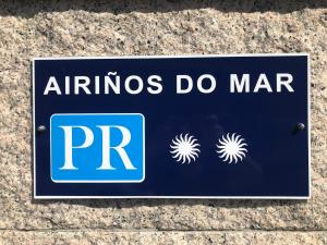 a blue sign that says afinos do mar at Airiños do Mar in Areas