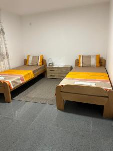 two twin beds in a room with at ANGELIKATOS in Golubac