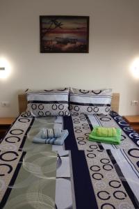 a bed with two pillows on top of it at Apartments Baja in Ulcinj